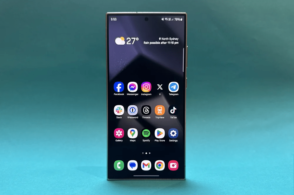 A Galaxy s24 Ultra standing up on a blue-green background.