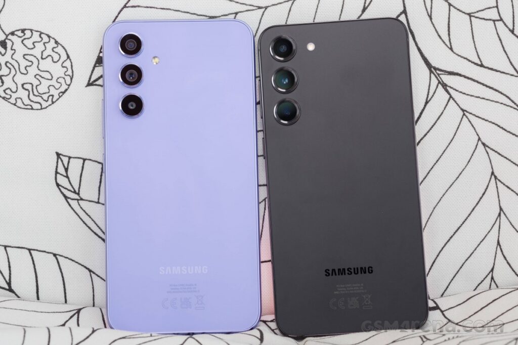 Two Samsung Galaxy a54s put side-by-side so you can see the backs. One is gray and one is purple.