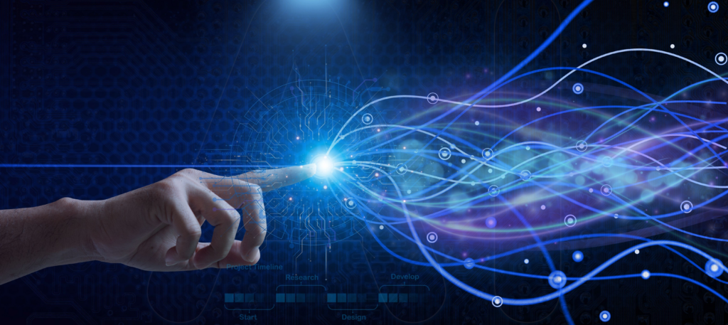 A human hand is reaching out with an extended index finger. A light is bursting from the finger and diffusing into multicolored tendrils snaking their way out into the world.