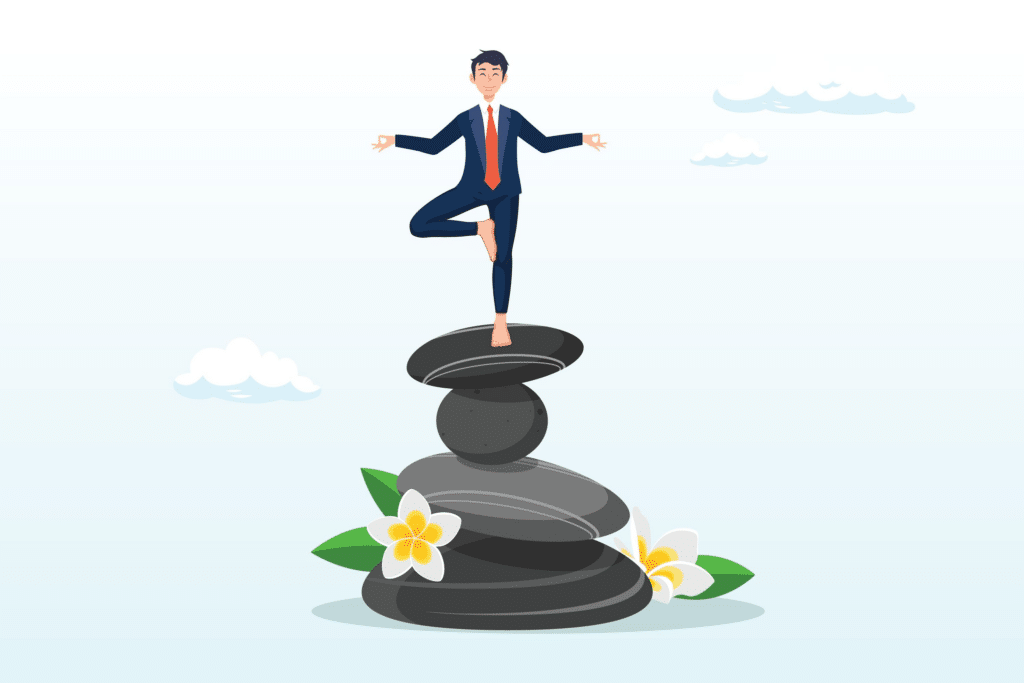A business person in a suit standing in the Yoga tree pose, balanced on one leg on to of several precariously stacked rocks. He appears to be very calm and confident.